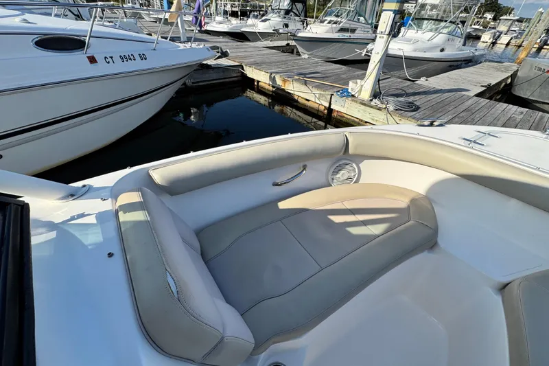 Slide: The Image of 2015 Pursuit DC 265 Dual Console boat docked at marina with cushioned seating. - 42