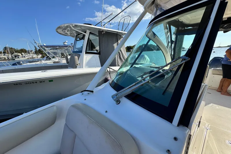 Slide: The Image of 2015 Pursuit DC 265 Dual Console boat docked at marina, sunny day. - 48