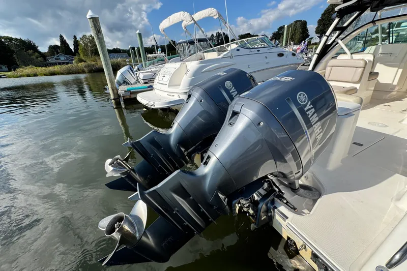 Slide: The Image of 2015 Pursuit DC 265 Dual Console with Yamaha outboard motors docked at marina. - 7