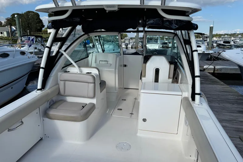 Slide: The Image of 2015 Pursuit DC 265 Dual Console boat interior at marina dock. - 9