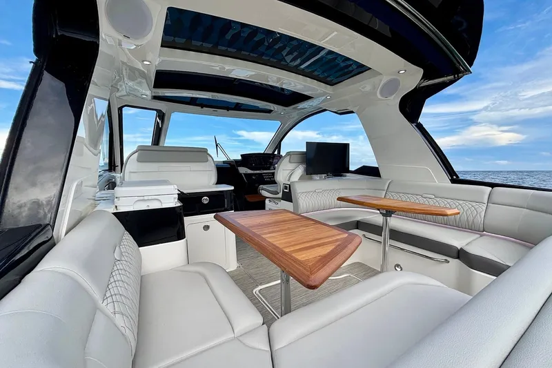 Slide: The Image of Luxurious interior of 2022 Sea Ray Sundancer 370 Outboard with elegant seating and wooden tables. - 10
