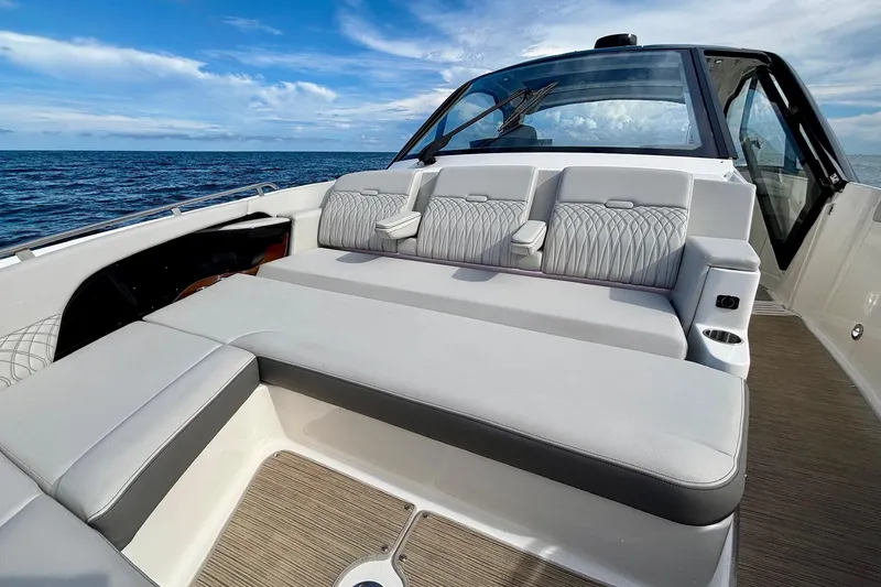 Slide: The Image of 2022 Sea Ray Sundancer 370 Outboard boat interior with luxurious seating and ocean view. - 22