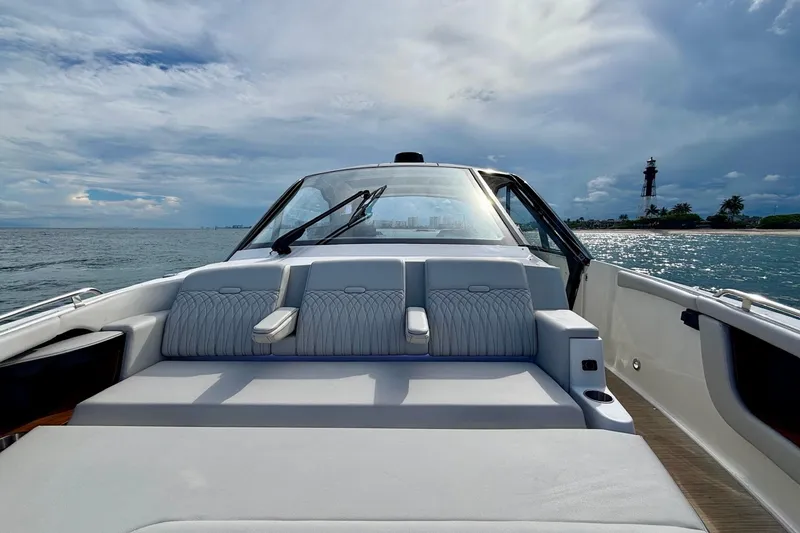 Slide: The Image of 2022 Sea Ray Sundancer 370 Outboard cruising near a lighthouse on a sunny day. - 23