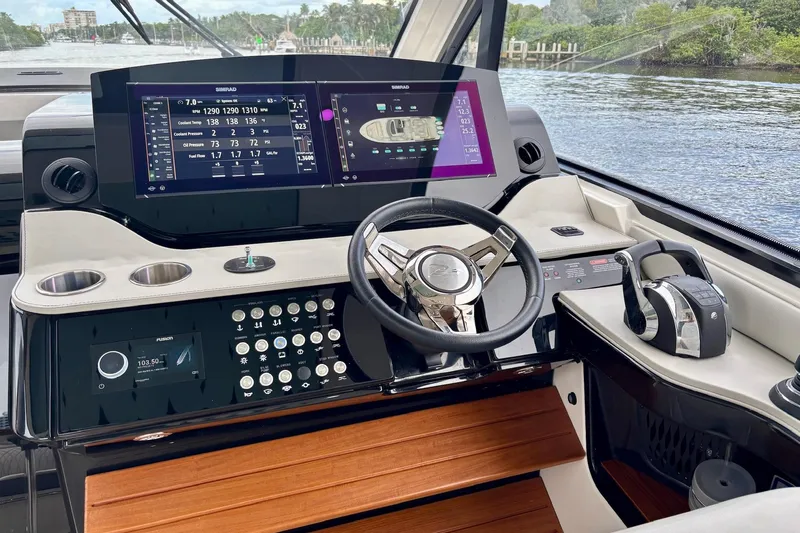 Slide: The Image of 2022 Sea Ray Sundancer 370 Outboard helm with advanced navigation displays and controls. - 26