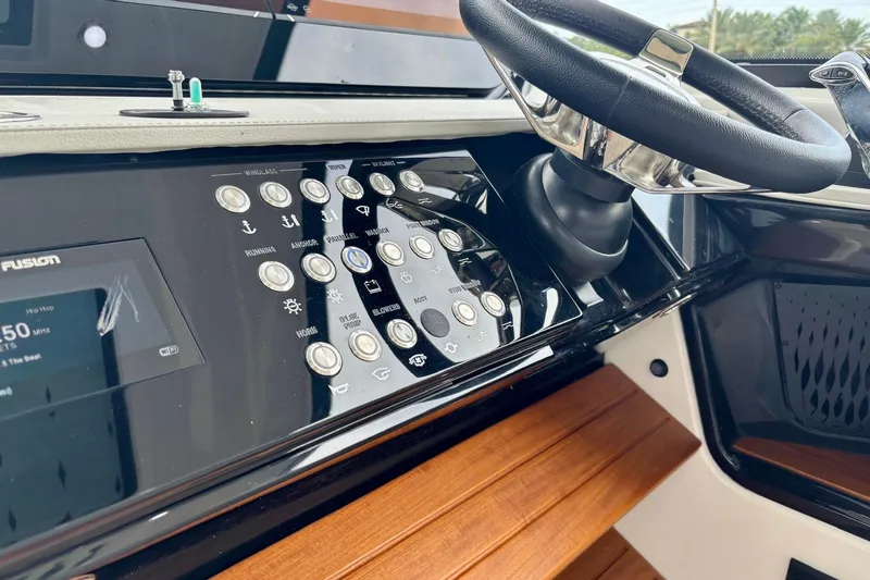 Slide: The Image of 2022 Sea Ray Sundancer 370 Outboard dashboard with steering wheel and control panel. - 27