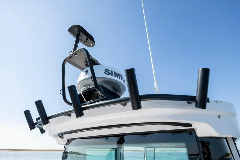 Slide: The Image of 2024 Axopar 28 CABIN boat roof with radar and rod holders. - 20