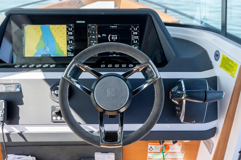 Slide: The Image of 2024 Axopar 28 CABIN dashboard with steering wheel and navigation display. - 23