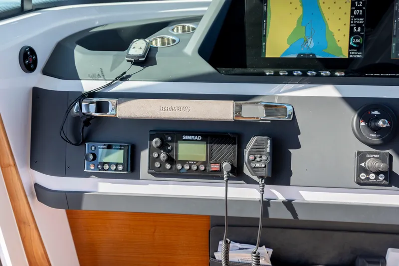Slide: The Image of 2024 Axopar 28 CABIN dashboard with navigation and communication equipment. - 24