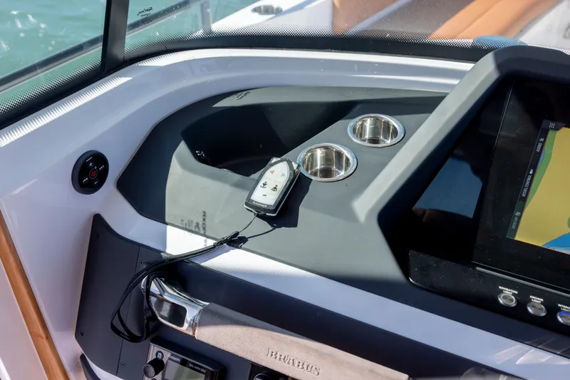 Slide: The Image of 2024 Axopar 28 CABIN dashboard with navigation screen and control panel. - 25