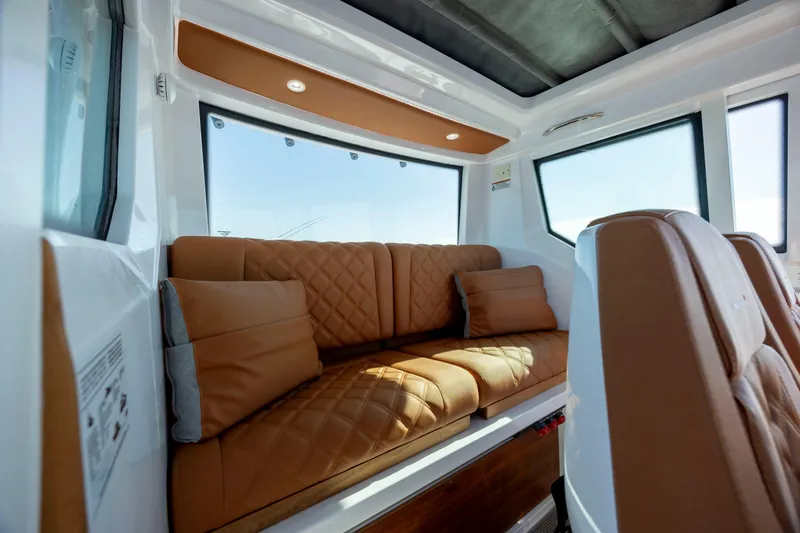 Slide: The Image of Luxurious interior of 2024 Axopar 28 CABIN with brown leather seating. - 27