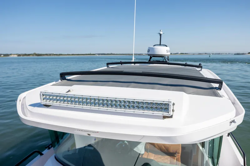Slide: The Image of 2024 Axopar 28 CABIN boat with LED light bar on calm water. - 33
