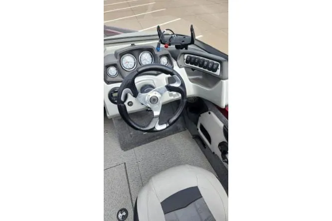 Slide: The Image of 2018 Tracker Targa V-18 Combo boat dashboard with steering wheel and instrument panel. - 2