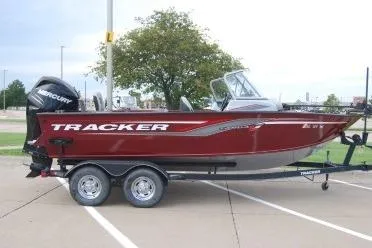 Slide: The Image of 2018 Tracker Targa V-18 Combo boat on trailer, parked outdoors. - 5