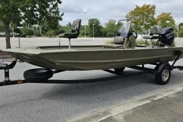 Slide: The Image of 2019 Tracker Grizzly 1860 CC boat on trailer in parking lot. - 4