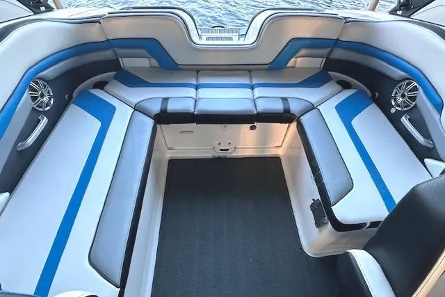 Slide: The Image of 2016 Yamaha Boats 242X E-Series interior with blue and gray seating design. - 12