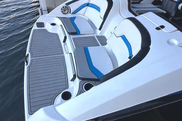 Slide: The Image of 2016 Yamaha Boats 242X E-Series interior with blue and white seating, stylish and spacious design. - 14