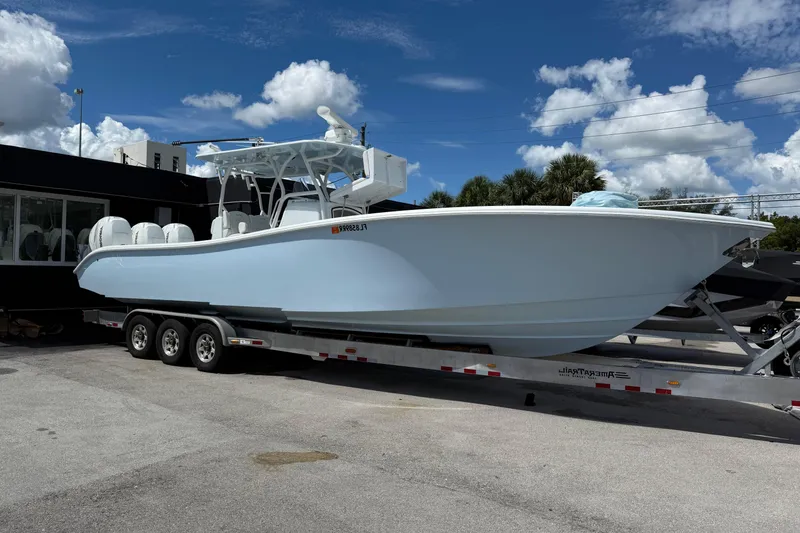 The Image of 2021 Yellowfin 36 Offshore boat on trailer under blue sky. - 1