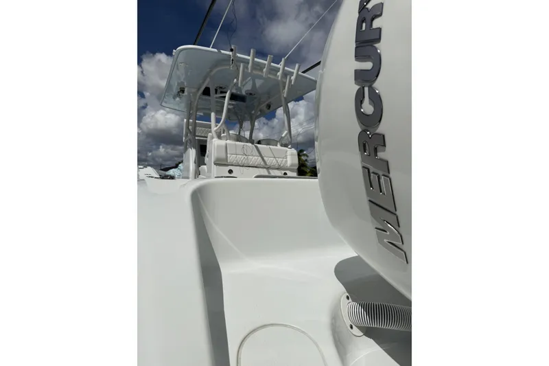 Slide: The Image of 2021 Yellowfin 36 Offshore boat with Mercury engine, under a cloudy sky. - 10