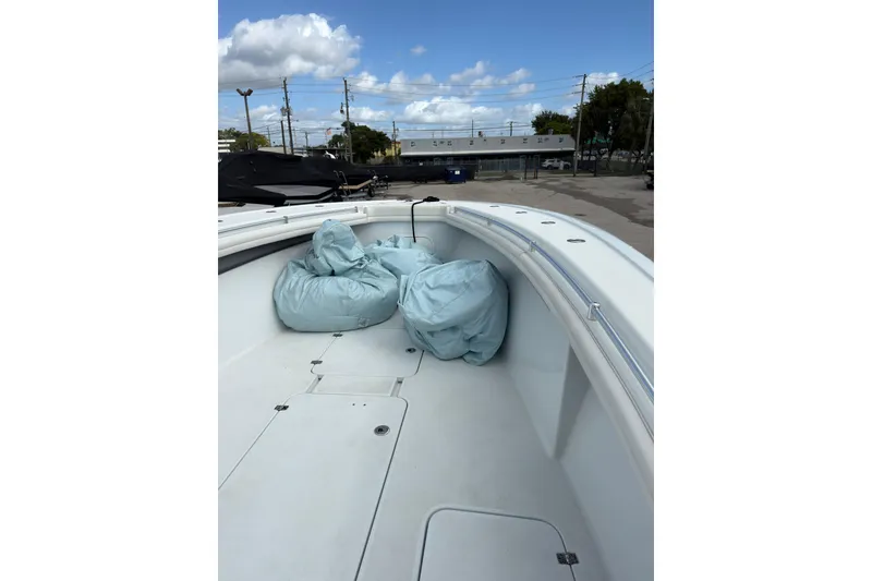 Slide: The Image of 2021 Yellowfin 36 Offshore boat deck with covered equipment under a blue sky. - 11