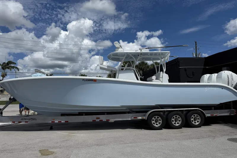 Slide: The Image of 2021 Yellowfin 36 Offshore boat on trailer under a partly cloudy sky. - 5