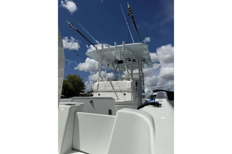 Slide: The Image of 2021 Yellowfin 36 Offshore boat with fishing rods under a clear blue sky. - 9