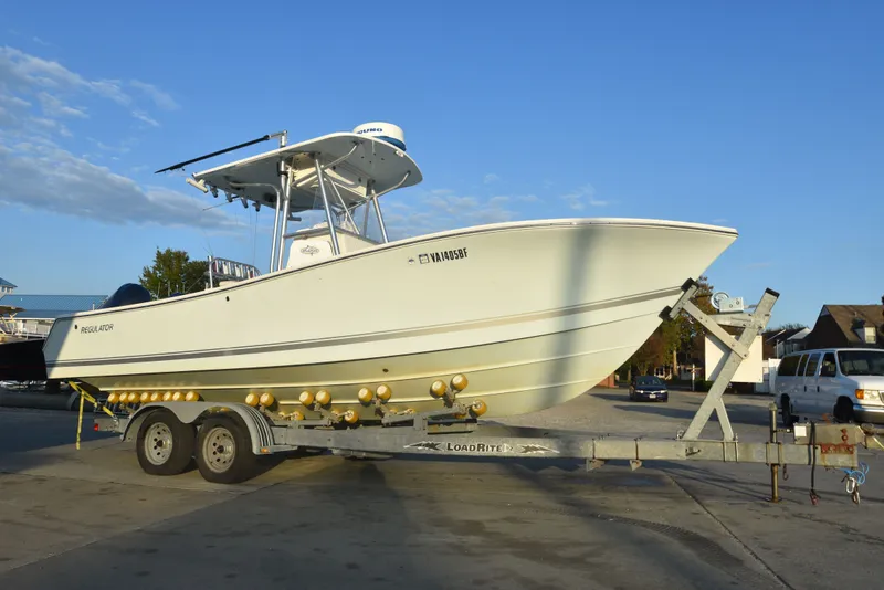 The Image of 2005 Regulator 24 Forward Seating boat on trailer under clear blue sky. - 0