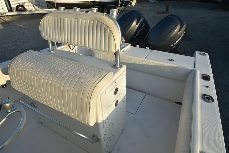 Slide: The Image of 2005 Regulator 24 Forward Seating boat interior with Yamaha engines, featuring white cushioned seating. - 12