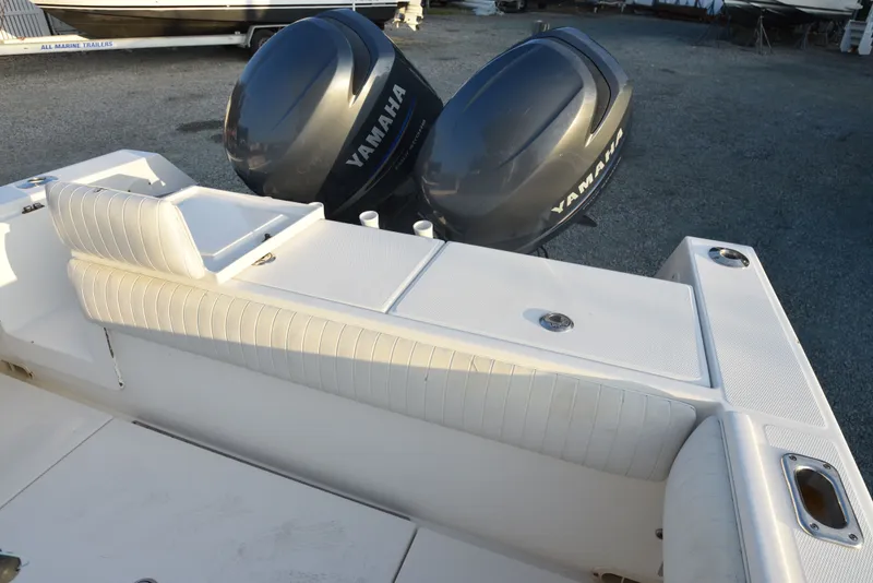 Slide: The Image of 2005 Regulator 24 Forward Seating boat with Yamaha engines, featuring white cushioned seating. - 13