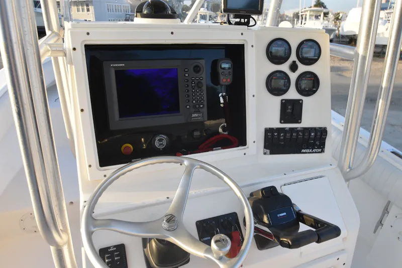 Slide: The Image of 2005 Regulator 24 Forward Seating boat dashboard with navigation equipment and controls. - 18