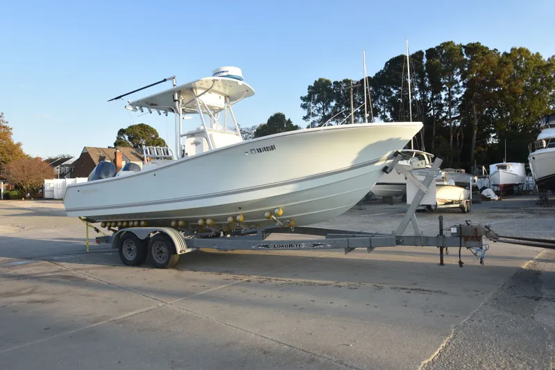 Slide: The Image of 2005 Regulator 24 Forward Seating boat on trailer in marina setting. - 2