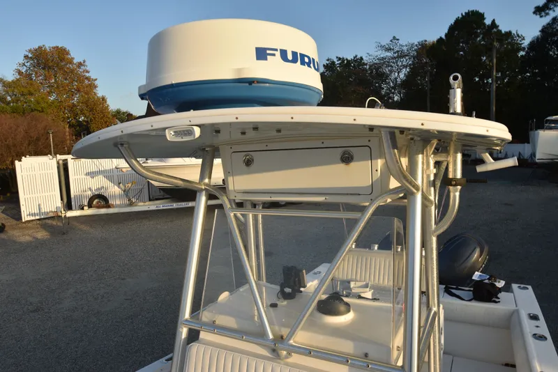 Slide: The Image of 2005 Regulator 24 Forward Seating boat with radar equipment, parked outdoors. - 24