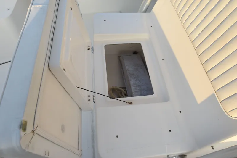 Slide: The Image of 2005 Regulator 24 Forward Seating boat storage compartment with open lid. - 26