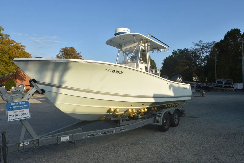 Slide: The Image of 2005 Regulator 24 Forward Seating boat on trailer, displayed outdoors. - 7