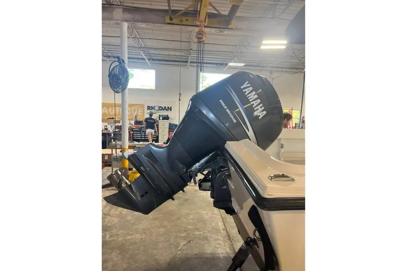 Slide: The Image of 2009 Parker 2100 Special Edition boat with Yamaha outboard motor in a workshop. - 3