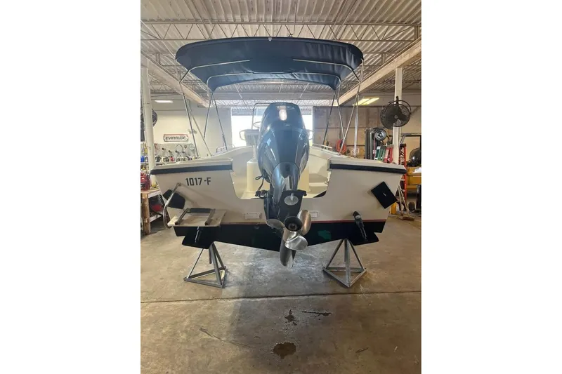 Slide: The Image of 2009 Parker 2100 Special Edition boat in a garage, rear view with motor. - 4