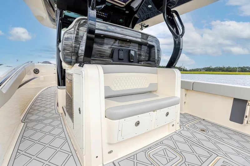 Slide: The Image of 2024 Scout 377 LXF boat interior with seating and storage, featuring elegant design and water view. - 11