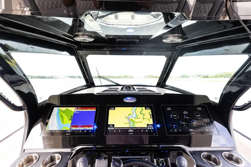 Slide: The Image of 2024 Scout 377 LXF boat dashboard with advanced navigation displays and controls and Skylight Hatch in Hardtop - 27