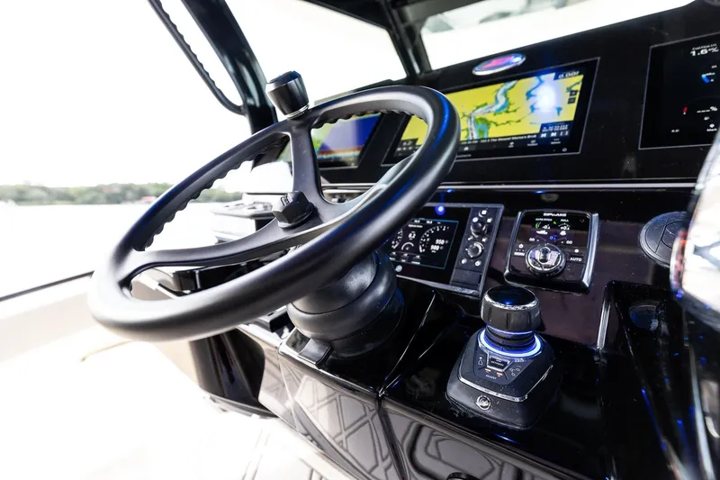 Slide: The Image of 2024 Scout 377 LXF boat dashboard with steering wheel and navigation controls. - 29