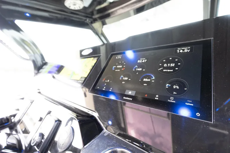 Slide: The Image of 2024 Scout 377 LXF boat dashboard with Garmin display and navigation controls. - 30