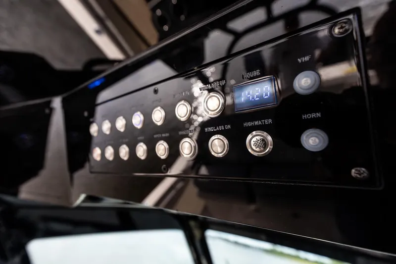 Slide: The Image of Control panel of 2024 Scout 377 LXF boat with digital display and buttons. - 32