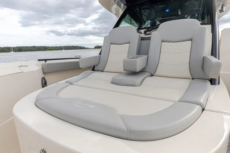 Slide: The Image of 2024 Scout 377 LXF boat with luxurious seating and elegant design on the water. - 47