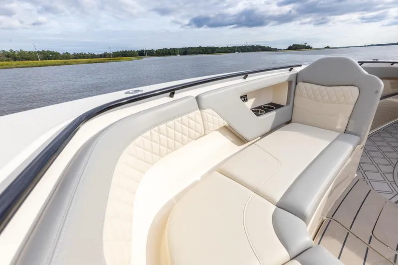Slide: The Image of Luxurious seating on 2024 Scout 377 LXF boat, featuring elegant design and waterfront view. - 49