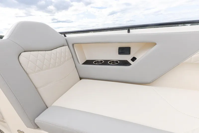Slide: The Image of 2024 Scout 377 LXF boat interior with luxurious seating and cup holders. - 51