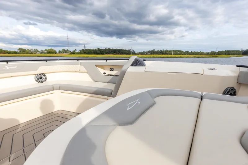 Slide: The Image of 2024 Scout 377 LXF boat interior with luxurious seating and scenic water view. - 52