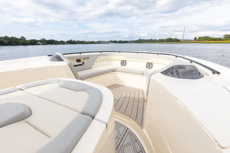 Slide: The Image of 2024 Scout 377 LXF boat interior with luxurious seating and scenic water view. - 54