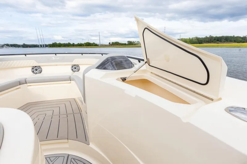 Slide: The Image of 2024 Scout 377 LXF boat interior with open storage compartment and seating area. - 55