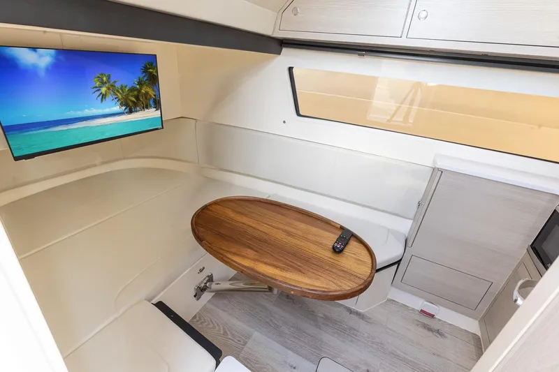 Slide: The Image of 2024 Scout 377 LXF cabin with TV, wooden table, and modern interior design. - 76
