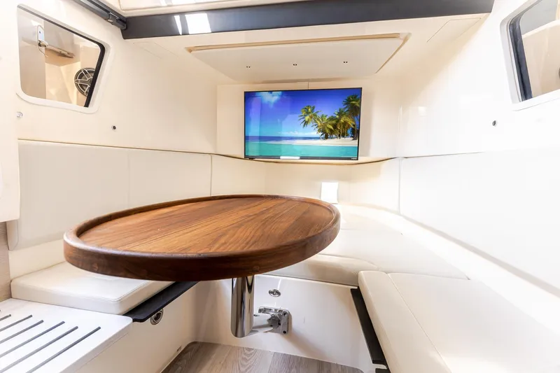 Slide: The Image of Luxurious interior of 2024 Scout 377 LXF boat with TV and wooden table. - 77