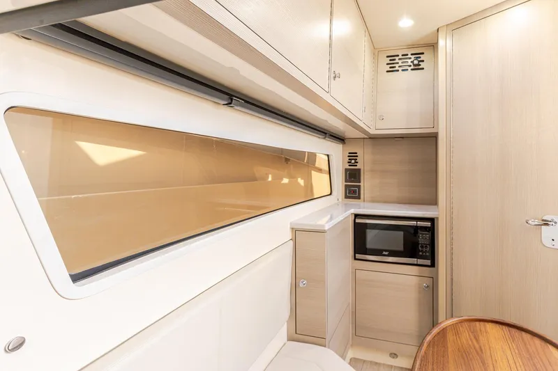 Slide: The Image of 2024 Scout 377 LXF interior with modern kitchenette, featuring microwave and sleek cabinetry. - 78