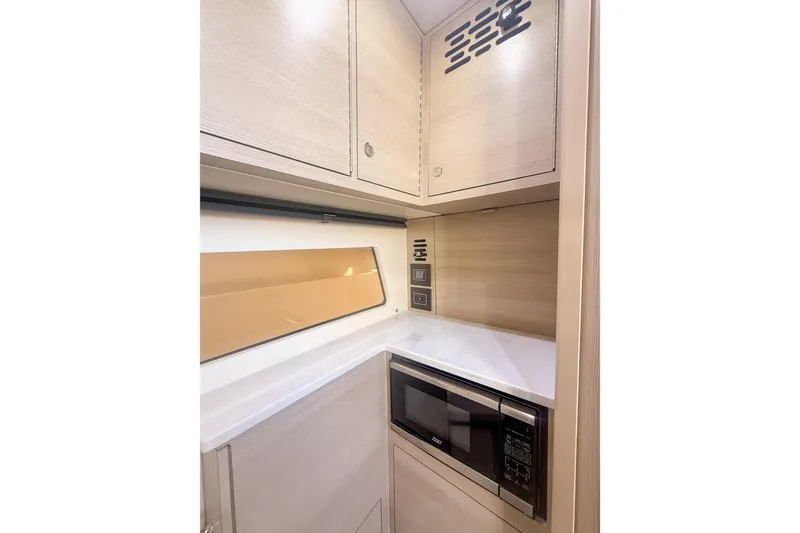 Slide: The Image of 2024 Scout 377 LXF interior with modern cabinetry and built-in microwave. - 82